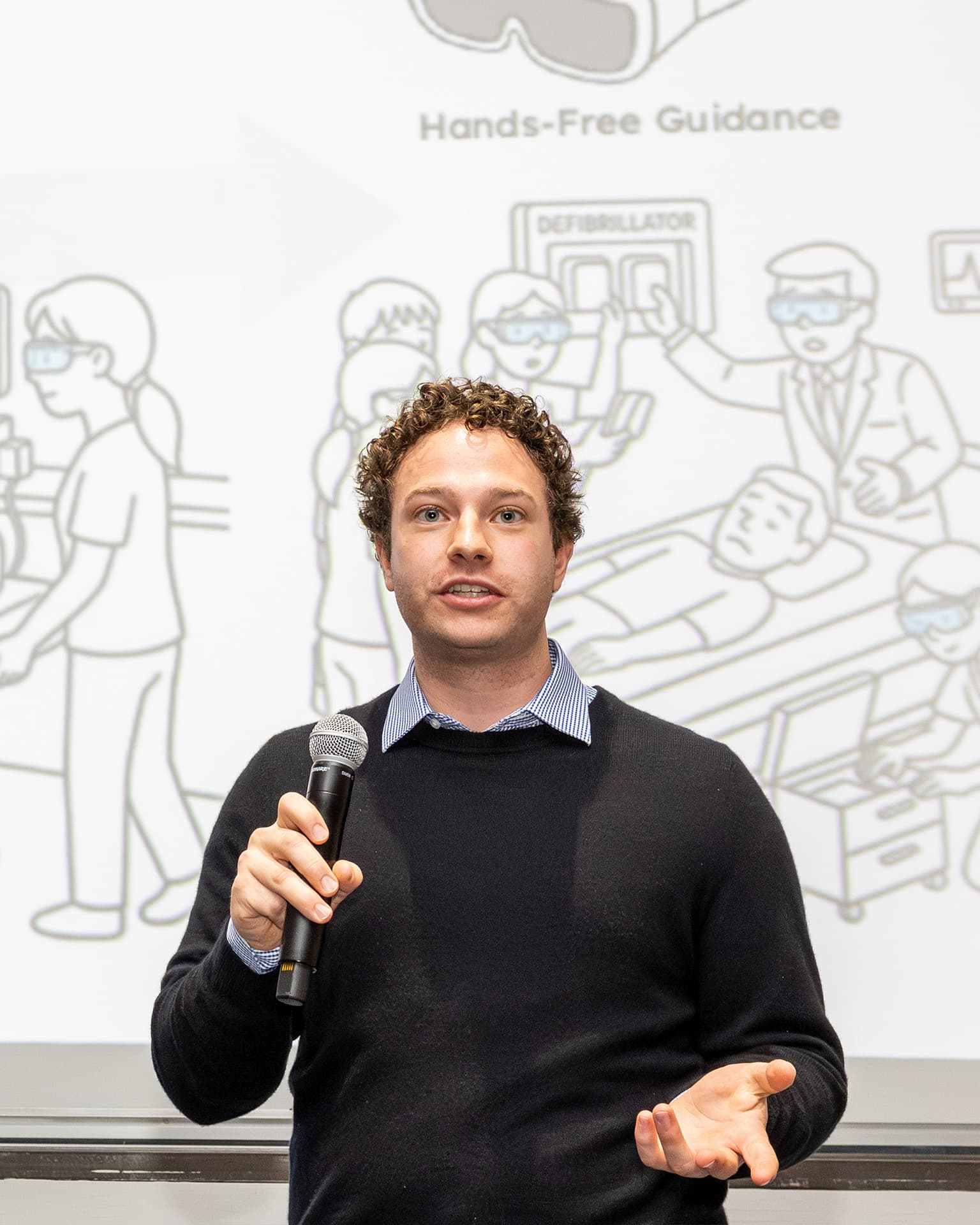 Presenting my thesis at 3MT at Cornell, speaking into a microphone